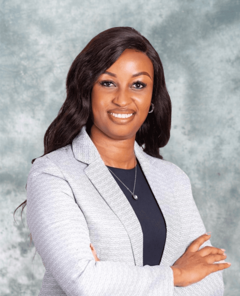 Monica Chege, marketing and communications executive, studio portrait in a light grey blazer